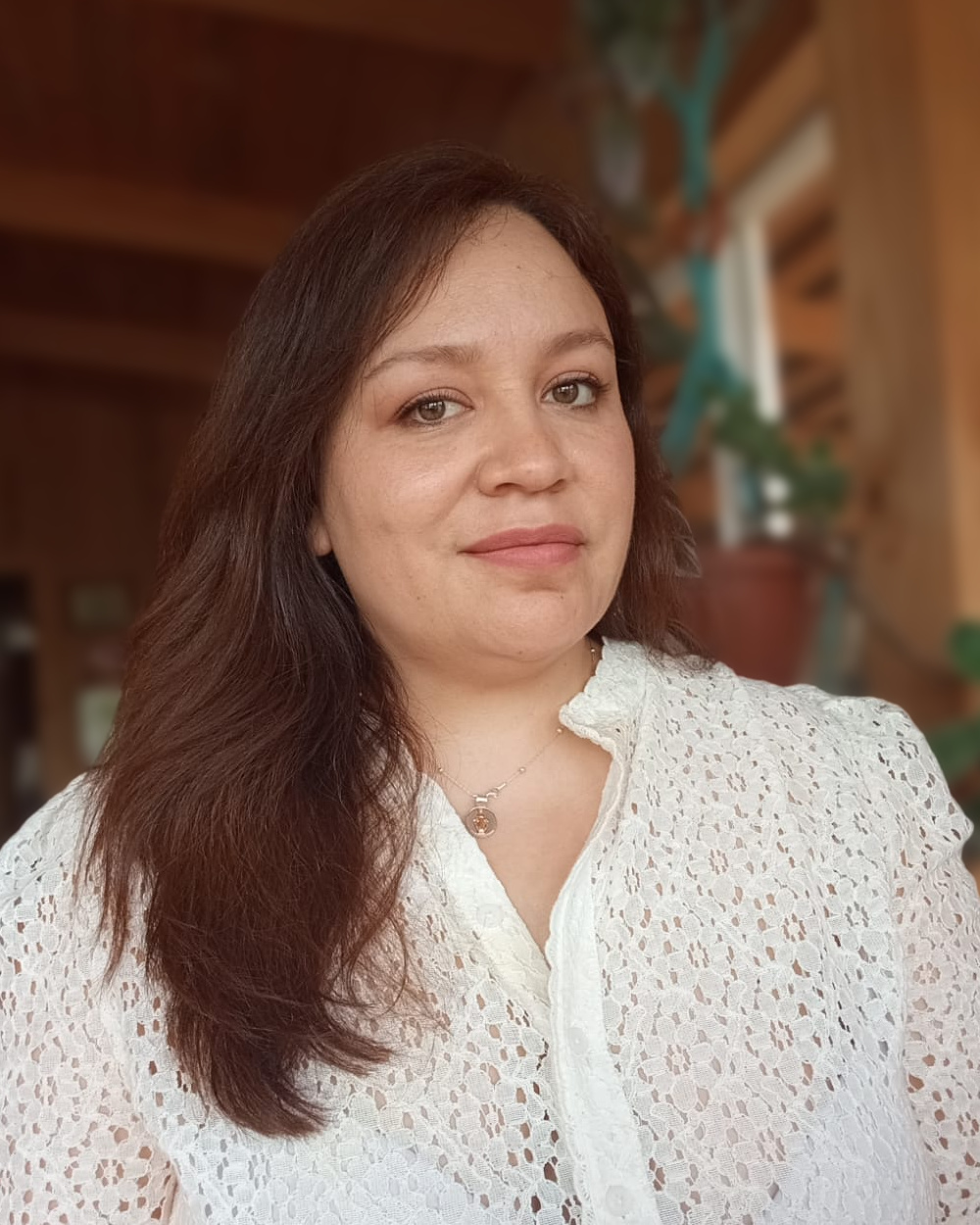 Katherina Espinoza, founder of Xanthoria Scientific Marketing, in a wooden room with plants in the background
